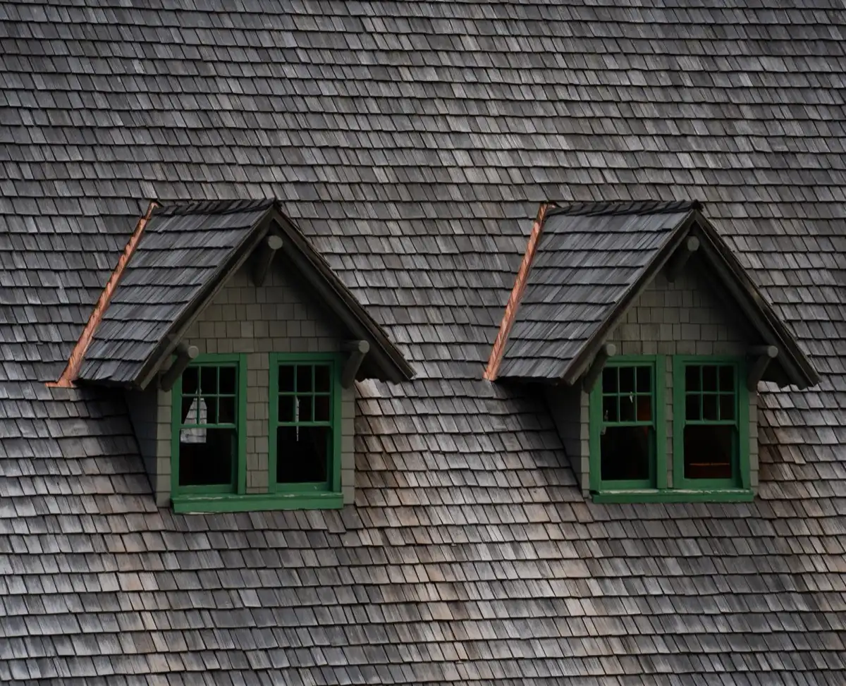 Dormers on a shingle roof in Birmingham, AL, where step flashing and kickout flashing carry water past the walls